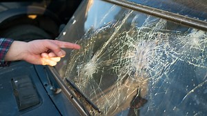 What caused the commotion that has caused chaos among residents after more than 3,000 cars were left with small holes and dents in their windshields?