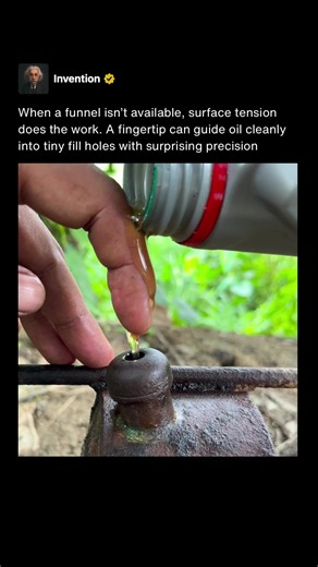 This technique is commonly called finger funneling, and it works by using a fingertip as a temporary guide channel to direct liquid into a small or awkwardly placed opening. Instead of pouring straight into the hole, the oil is poured onto the finger, where it naturally follows the skin downward into the fill port. This reduces splashing and makes it much easier to hit tiny openings that are hard to aim for with a bottle or can spout. The science behind it comes from surface tension and adhesion