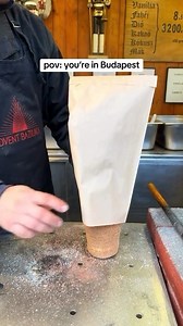 Spiraled perfection 😋 A chimney cake, also known as Kürtőskalács in Hungarian, is a delightful Eastern European pastry with a unique twist. Imagine a golden brown, crispy cylinder of pastry, hollow on the inside like a chimney (hence the name!). It’s typically about the size of your forearm and has a spiral pattern from being wrapped around a special rolling pin or spit. Traditionally, chimney cakes are enjoyed plain or dusted with cinnamon sugar or ground walnuts. Modern variations go wild, of