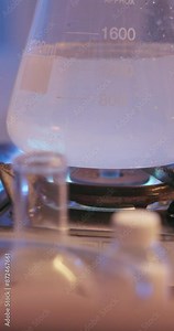 Chemistry, science and beaker boiling in lab for experiment on drugs and meth development closeup. Glass, liquid and gas for scientific research, test and medical study on stove with substance abuse Stock Video