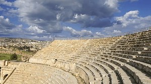 Amphitheater in Jerash (Gerasa of Antiquity), capital and largest city of Jerash Governorate, Jordan. Against the background of a beautiful sky with clouds. 4K, time lapse, with zoom
