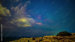 Milky Way galaxy moving across night sky with forming cloudscape, time lapse view