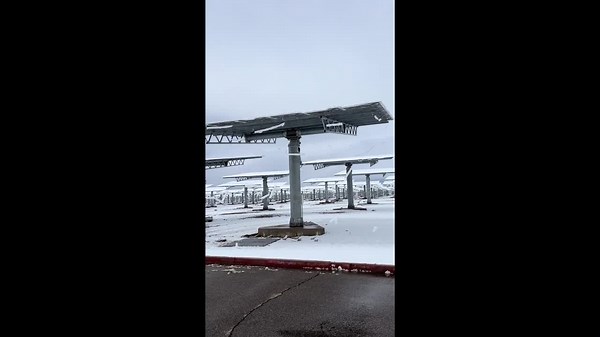 Snow slides off solar panels at Crescent Dunes Solar Energy Project, Nevada, USA