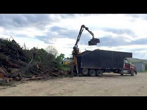 Unloading Brush from Rear Mount Grapple Truck