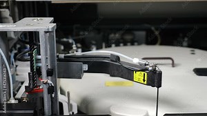 Modern medical laboratory. Automated medical analysis process. Tech robotic arms move with human analysis samples separating excess cells in Oncology laboratory. Professional medical device for human