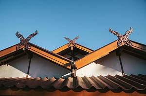 Detail of rural Thai hip roof house in the Akha village of Maejantai...
