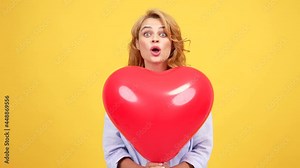 girl with amazed face blow kiss behind heart love party balloon, kiss