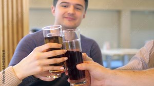 Happy friends eat pizza together, sitting at the pizza shop's copy table. Smile