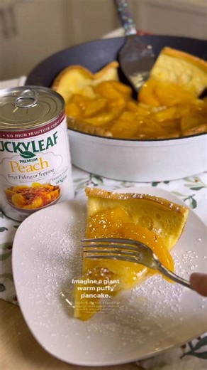 Holiday breakfast and brunch just got a major glow-up… say hello to this peachy Dutch Baby topped with Lucky Leaf Peach Fruit Filling. 🍑🥰 It’s light, airy, fluffy and the peaches are the perfect topping! Here’s how to make it: Melt 4 tbsp salted butter in an oven-safe pan at 425°F, then blend up the simplest batter ever: ½ cup flour, 1 tbsp sugar, 3 eggs, ½ cup milk. Pour it into the hot pan and bake until beautifully puffed (15–20 min), then drop the oven to 300°F for 5 more minutes. The gran