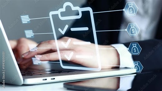 Business person using laptop to manage tasks and check off items on a list in office setting during work hours.