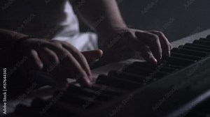 Musician playing keyboard. Electric piano keyboard playing. Piano keyboard music player. Close up of male hand playing piano keys. Rock music playing keyboard piano