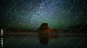 Astrophotography time lapse footage with zoom in motion of star trails over lone rock in Lake Powell, Glen Canyon National Recreation Area, Utah