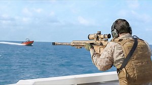 US Marines sniper in action shooting fast moving boat