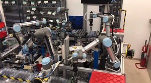 ✌️ words: collaborative robots. Look at this teamwork. A rotary table with five robots surrounding it. Working together. Collaborating. Beautiful 🥹 Cable management system by igus. #robotics #automation #cobots | Universal Robots