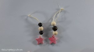 Make your own Christmas beaded star ornaments with wood beads, baking clay, and a few easy steps. This craft allows you to customize the color, and size of your ornament. https://thecraftyblogstalker.com/christmas-beaded-star-ornaments/ | The Crafty Blog Stalker | Facebook