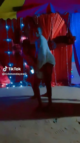 Energetic Dance Duo in Colorful Tent Setting