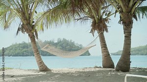 Hammock hanging between two coconut palm trees with tropical islands and beaches. Perfect vacation with all included spa hotel or resort. Relaxation in warm day and turquoise water. Holiday vibes