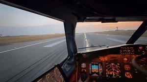 Forward cockpit pilot captain view during take off takeoff roll from airport runway at Copenhagen airport at sunrise