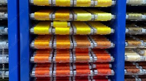Sewing threads multi colored background. Colorful thread spools used in fabric and textile industry