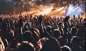 Many people were busy raising their hands. The crowd of fans waved. Epic live music concert atmosphere
