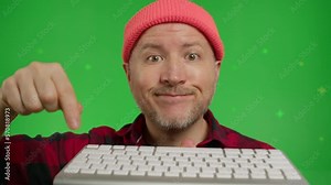 Extreme close-up of man pressing enter key on keyboard. Male user pushes enter button on pc on a Green Screen, Chroma Key