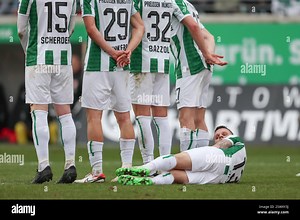 22 February 2025, North Rhine-Westphalia, Münster: Soccer: Bundesliga 2, SC Preußen Münster - SSV Jahn Regensburg, matchday 23 at the Stadion an der Hammer Straße. Münster's Florian Pick lies on the pitch behind a wall during a free kick. Photo: Friso Gentsch/dpa - IMPORTANT NOTE: In accordance with the regulations of the DFL German Football League and the DFB German Football Association, it is prohibited to utilize or have utilized photographs taken in the stadium and/or of the match in the for