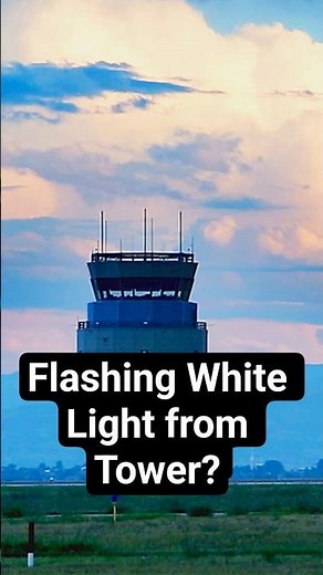 What does a flashing white light from tower mean?