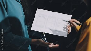 UX developer and ui designer brainstorming about mobile app interface wireframe design with customer breif and color code. business working