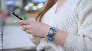 Finger of woman touching scroll page app on mobile phone. Relaxed young woman using smart phone surfing social media, checking news, playing mobile games or texting messages on mall. Millennial lady