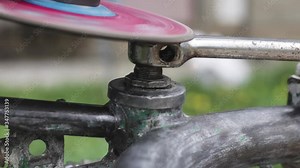 Sparks flying from a grinding machine working on an old metal piece.
