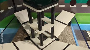 Earthquake simulator and building stability tester. Demonstration of the destructive power of nature on a model. Stock Video