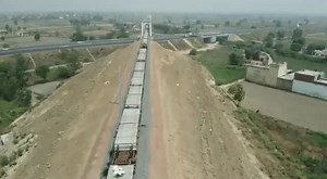 Dedicated Freight Corridor Infra Work on Fast Track! Aerial view of the New Track Construction (NTC) machine laying tracks at the Major Road Under Bridge-138 passing over Delhi-Meerut Expressway including Major Bridge-139 connected with viaduct on Khurja-Pilkhani section in U.P. #DFC #Infra4India #NTC #IndianRailways | Ministry of Railways, Government of India