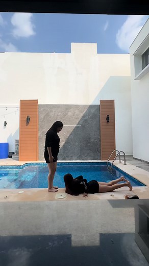 Summer Poolside Fun: Young Woman Jumps into the Pool