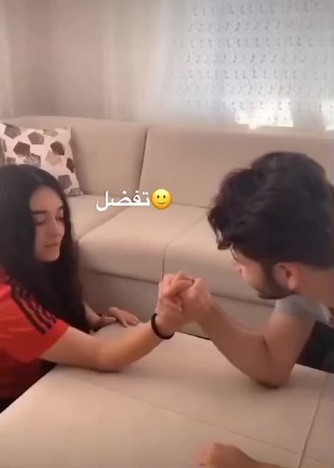 Arm-Wrestling Challenge in Cozy Living Room
