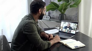 Video conference call. Indian smart freelancer or IT specialist, sit at a desktop at home or in office, communicating via video call with colleagues of different nationalities, discussing work issues