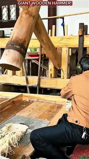 Giant Wooden Hammer Pounding Tree Bark into Fine Paper Fiber.