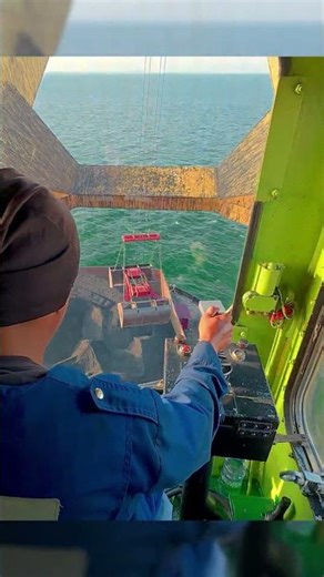 Crane operator POV Loading Coal on Cargo Vessel