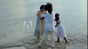 Black skin family travel together on the beach. Relaxing and recreation on summer holiday.