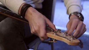 Re-stringing a bass guitar