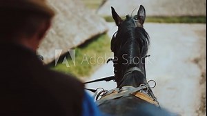 First person perspective of man riding horse on countryside road leading along limestone rocks