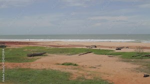 Wide shot waves breaking, waves break on an empty, pristine beach in Muttom, India.