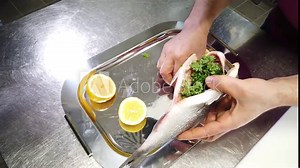 Chef stuffing fish dorade