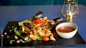 Zoom in on delicious and healthy plateau with cooked seafood on restaurant table