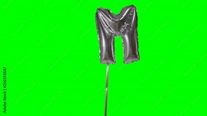 Letter M from alphabet helium silver balloon floating on green screen Stock Video