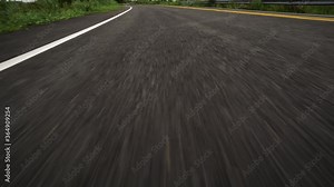 Front pov view of fast car driving on asphalt road