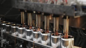 Production line for bottling drinks and beer at the plant. The process of automatically filling metal cans with a drink. Aluminum cans for drinks. Beverage production and bottling plant.