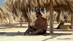 Relaxing on the beach with laptop