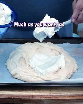 Smoked Pavlova Made Simple Decorating with Cream and Fresh Fruit