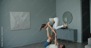 Yoga couple practice. Couple young sporty peoplepracticing acrobatic yoga lesson with partner, man and woman in yogi exercise, making difficult exercises for body keeping balance. High quality 4k Stock Video