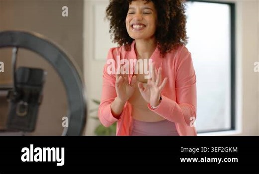 Woman raising hands and waving, thanking, blowing kisses using ring light and phone at home office. Lighting, communication, connection, lifestyle, modern, friendly, digital Stock Video Footage - Alamy